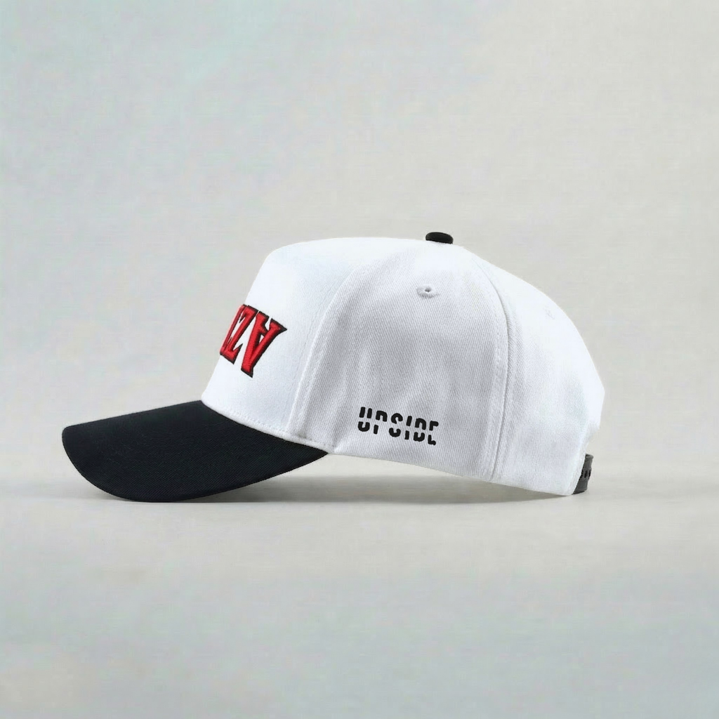 White and black cap with red and black text on a light gray background