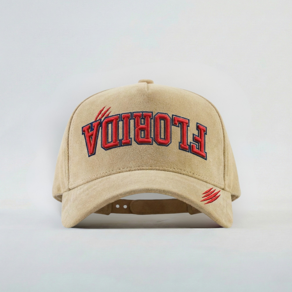 Beige cap with 'FLORIDA' embroidered upside down in red on a light gray background