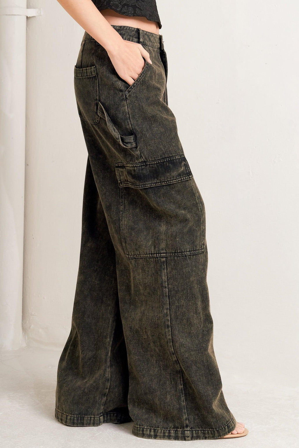 Person wearing wide-leg jeans on a plain background