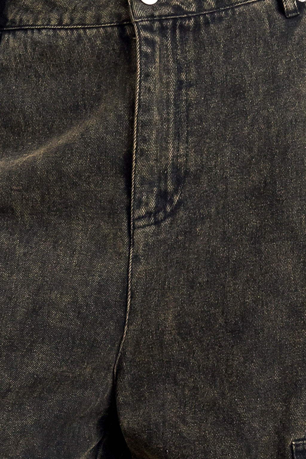 Close-up of dark denim fabric with stitching details