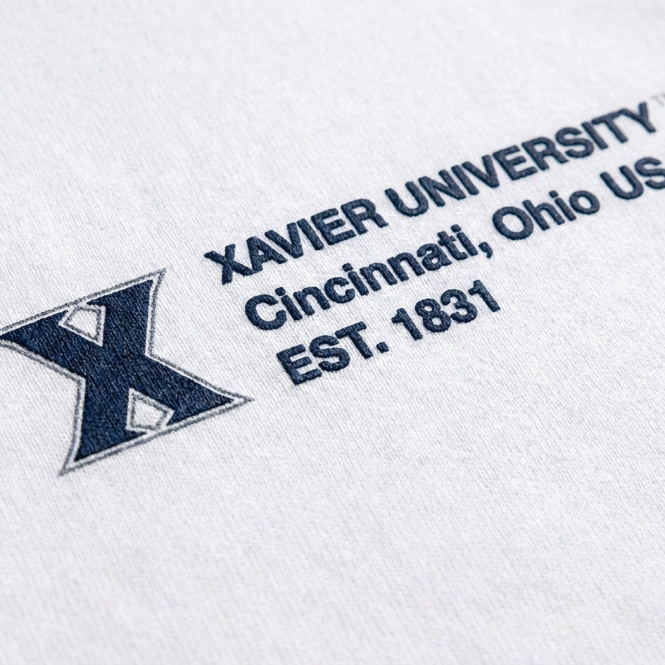 Embroidered Xavier University logo on a white background