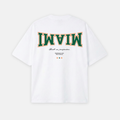 White t-shirt with 'MIAMI' text in green and red on a white background
