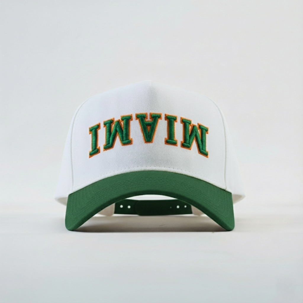 White cap with green brim and 'MIAMI' text on a white background