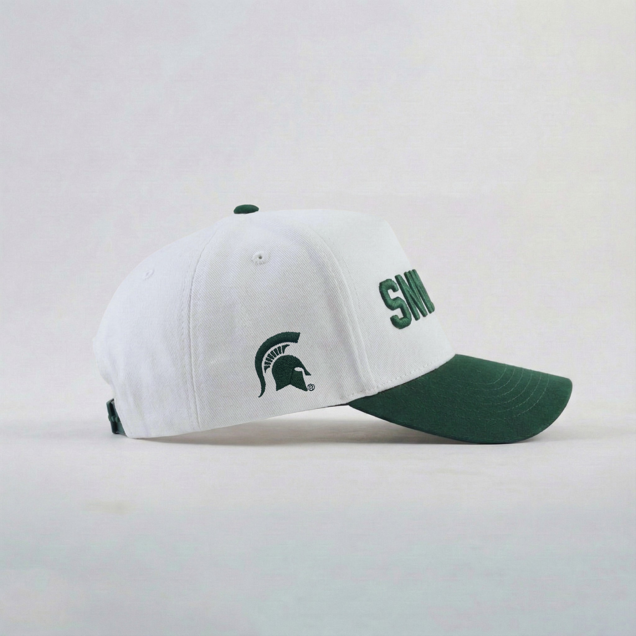 White and green cap with logo on a light gray background