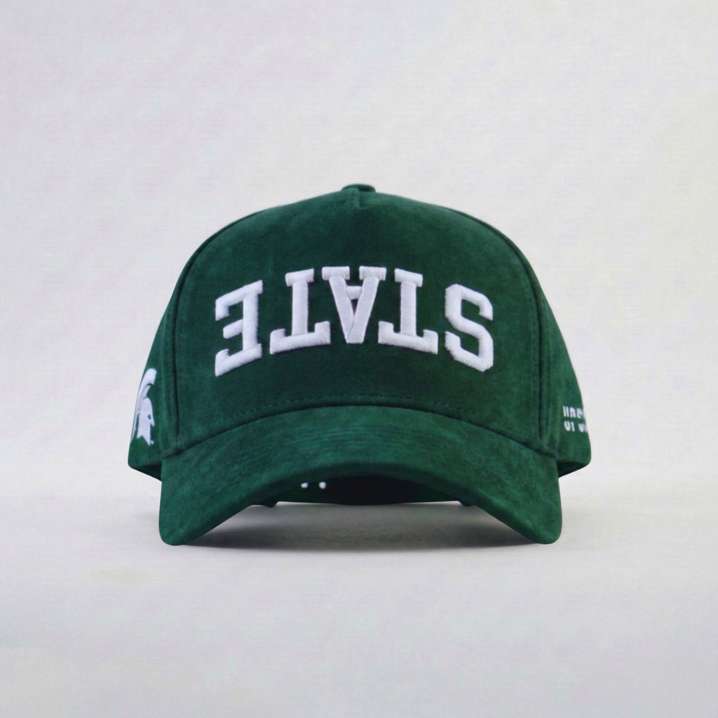 Green cap with 'STATE' upside down embroidered on a white background