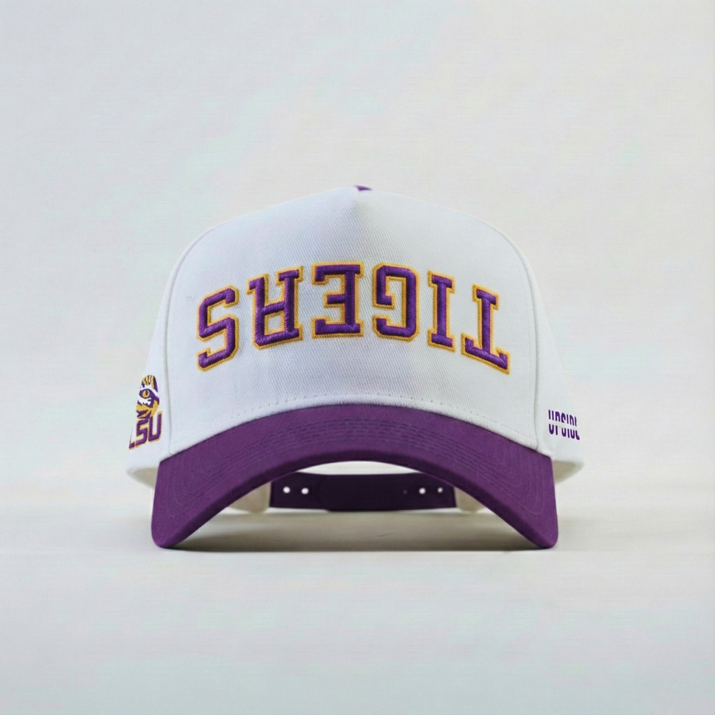 White and purple cap with 'Tigers' upsidedown text on a light gray background