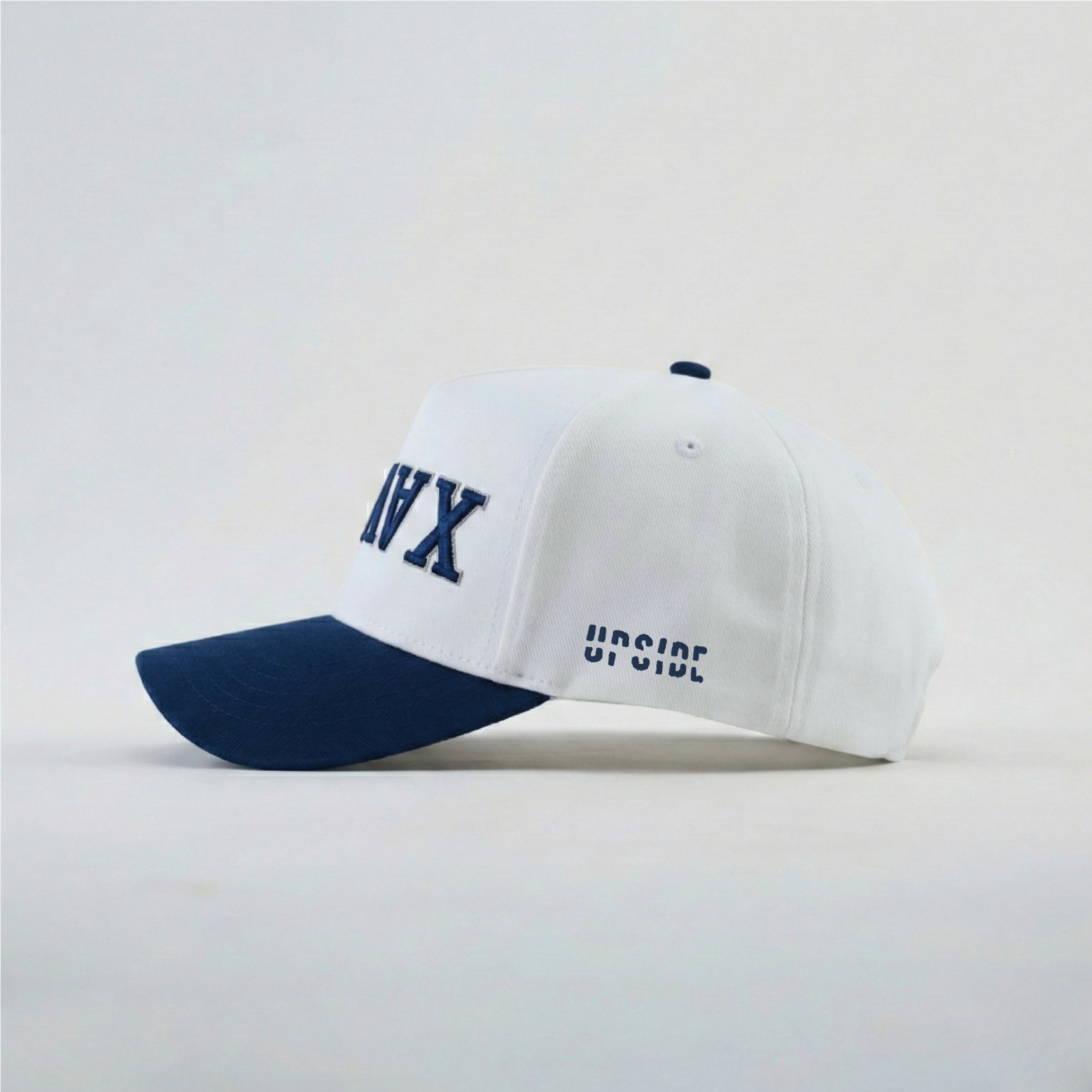 White and navy cap with text on a light gray background